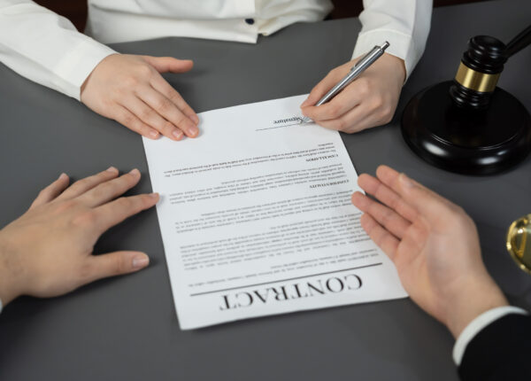 Lawyer signing contract, professional lawyer in law firm library drafting legal document or contract agreement ensuring lawful protection for client's dispute as fairness advocate concept. Equilibrium